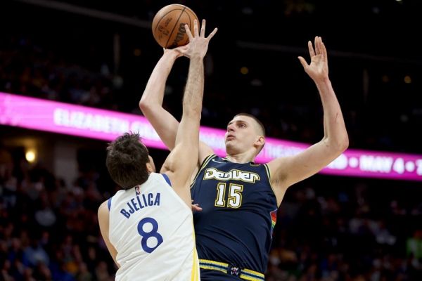 Nikola Jokic #15 of the Denver Nuggets puts yp a shot over Nemanja Bjelica #8 of the Golden State Warriors in the first quarter during Game Four of the Western Conference First Round NBA Playoffs at Ball Arena on April 24, 2022 in Denver, Colorado. PHOTO | AFP