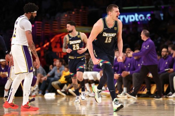 Nikola Jokic #15 of the Denver Nuggets reacts after scoring as Anthony Davis #3 of the Los Angeles Lakers looks on during the second half of a game at Crypto.com Arena on April 03, 2022 in Los Angeles, California. PHOTO | AFP