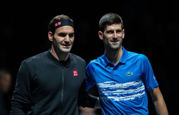 Novak Djokovic (R) of Serbia and Roger Federer of Switzerland pose for photos before their singles group match at the ATP World Tour Finals 2019 in London, Britain on Nov. 14, 2019. PHOTO | PA Images