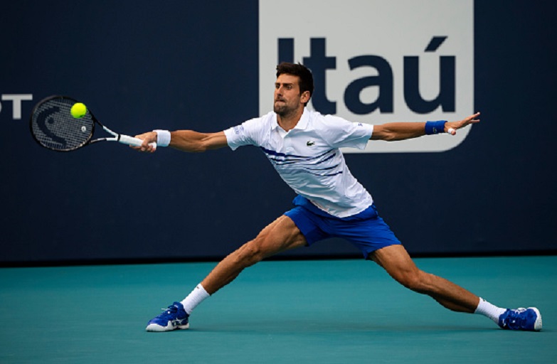 Novak Djokovic of Serbia hits a backhand against Federico Delbonis of Argentina in the third round of the men's singles in the Miami Open at the Hard Rock Stadium on March 24, 2019 in Miami Gardens, Florida. PHOTO/GettyImages