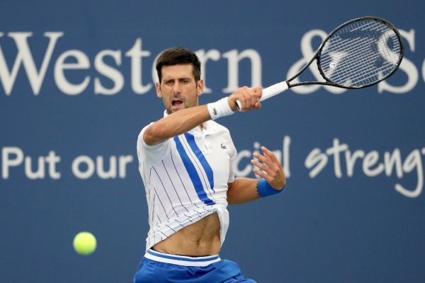 Novak Djokovic of Serbia returns a shot to Milos Raonic of Canada in the men's singles final of the Western & Southern Open at the USTA Billie Jean King National Tennis Center on August 29, 2020 in the Queens borough of New York City. PHOTO | AFP