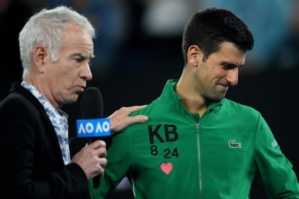 Novak Djokovic of Serbia wears the initials and numbers of Kobe Bryant on his jacket ashe is interviewed by John McEnroe after winning his fifth round match against Milos Raonic of Canada on day nine of the Australian Open tennis tournament at Rod Laver Arena in Melbourne, Tuesday, January 28, 2020. PHOTO | AFP