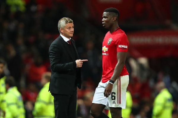 Ole Gunnar Solskjaer the head coach / manager of Manchester United speaks to Paul Pogba of Manchester United before the penalty shoot out during the Carabao Cup Third Round match between Manchester United and Rochdale AFC at Old Trafford on September 25, 2019 in Manchester, England.PHOTO/ GETTY IMAGES