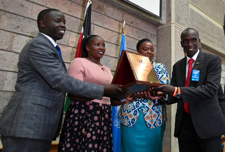 Olympic champion and world marathon record holder, Eliud Kipchoge (right) receives his UN Person of the Year 2018 plaque at the Nairobi offices of the organisation in Gigiri on Wednesday, October 24, 2018. PHOTO/Courtesy/UN 