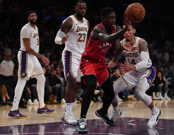 Pascal Siakam #43 of the Toronto Raptors passes in front of Danny Green #14, LeBron James #23 and Anthony Davis #3 of the Los Angeles Lakers during a 113-104 Raptors win at Staples Center on November 10, 2019 in Los Angeles, California. PHOTO | AFP