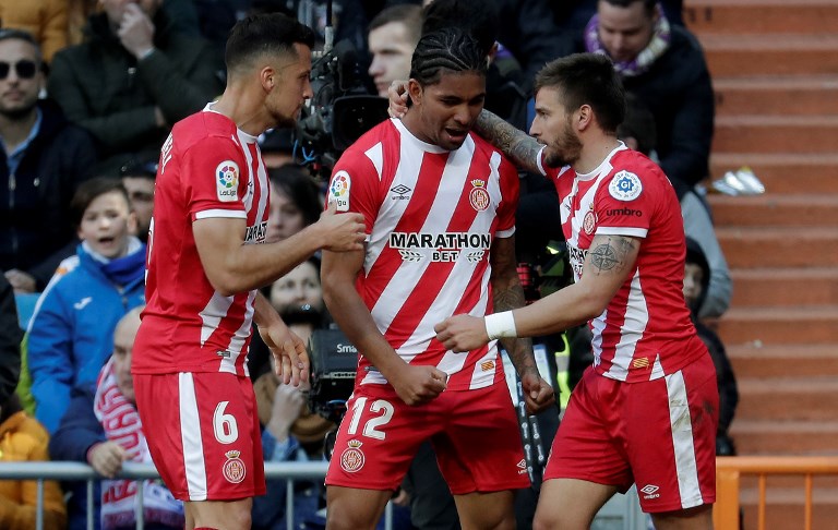 Portu (R) of Girona celebrates with his teammates Alex Granell (L) and Douglas Luiz (C) after scoring a goal during La Liga soccer match between Real Madrid and Girona at Santiago Bernabeu Stadium on Madrid, Spain on February 17, 2019. PHOTO/AFP