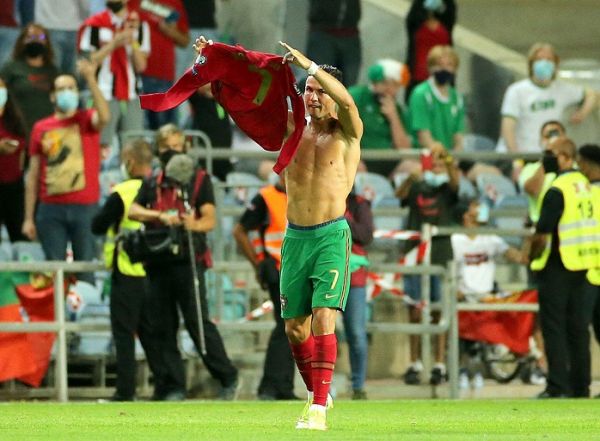 Portugal's Cristiano Ronaldo holds up his shirt to to the fans after scoring his sides second goal during the 2022 FIFA World Cup Qualifying match at the Estadio Algarve, Portugal.