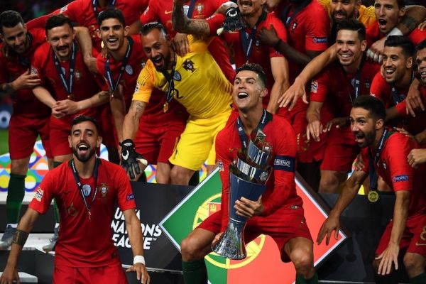 Portugal's forward Cristiano Ronaldo (C) holds the trophy as he celebrates with teammates after the UEFA Nations League final football match between Portugal and The Netherlands at the Dragao Stadium in Porto on June 9, 2019. PHOTO/AFP