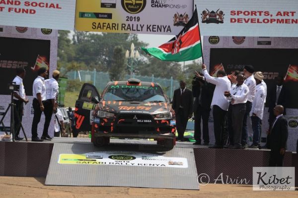 President Uhuru Kenyatta (with flag), sends of champion Carl 'Flash' Tundo on his way for the 2019 Safari Rally WRC Candidate Event at MISC Kasarani, on Friday, July 5, 2019. PHOTO/Courtesy