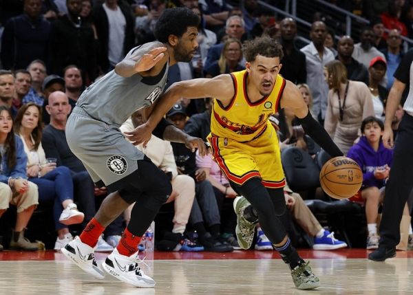 rae Young #11 of the Atlanta Hawks drives against Kyrie Irving #11 of the Brooklyn Nets during the second half at State Farm Arena on April 2, 2022 in Atlanta, Georgia. PHOTO | AFP