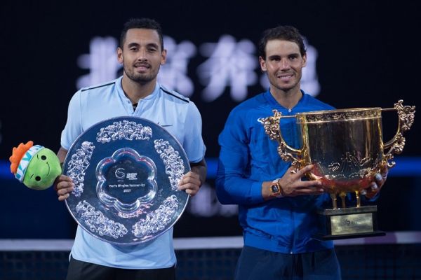 Rafael Nadal of Spain (R) holds the trophy after winning the men's singles final match against Nick Kyrgios (L) of Australia at the China Open tennis tournament in Beijing on October 8, 2017. PHOTO | AFP