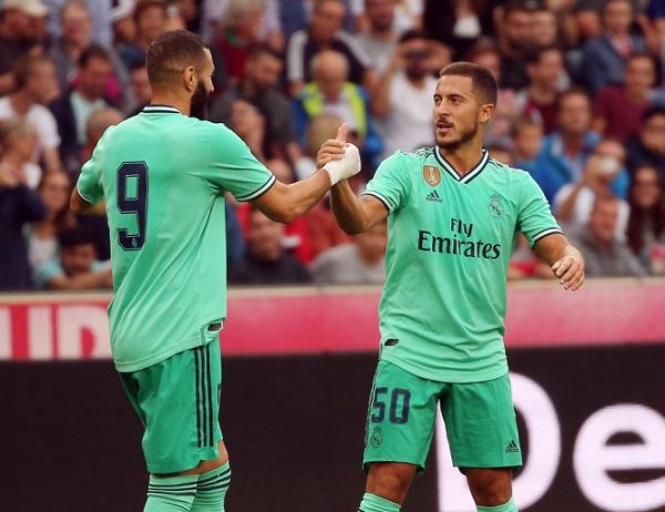 Real Madrid's forward Eden Hazard celebrates scoring with his team-mate Real Madrid's French forward Karim Benzema (L) during the pre-Season friendly football match FC Red Bull Salzburg v Real Madrid in Salzburg, Austria on August 7, 2019. PHOTO | AFP