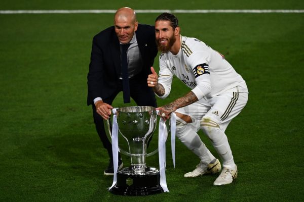 Real Madrid's French coach Zinedine Zidane (K) and Real Madrid's Spanish defender Sergio Ramos celebrate with the trophy after winning the Ligs title after the Spanish League football match between Real Madrid CF and Villarreal CF at the Alfredo di Stefano stadium in Valdebebas, on the outskirts of Madrid, on July 16, 2020. PHOTO | AFP