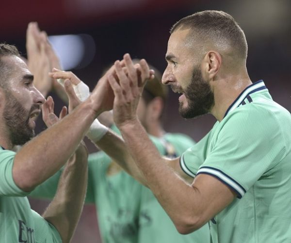 Real Madrid's French forward Karim Benzema (R) celebrates after scoring a goal during the Spanish league football match between Sevilla FC and Real Madrid CF at the Ramon Sanchez Pizjuan stadium in Seville on September 22, 2019. PHOTO | AFP