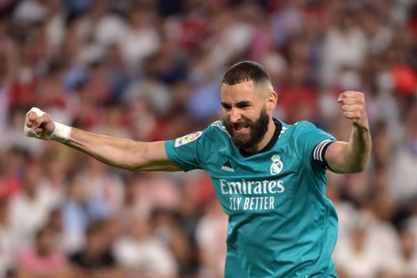 Real Madrid's French forward Karim Benzema celebrates after Real Madrid's Spanish defender Nacho Fernandez scored a goal during the Spanish League football match between Sevilla FC and Real Madrid CF at the Ramon Sanchez Pizjuan stadium in Seville on April 17, 2022. PHOTO | AFP