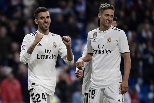 Real Madrid's Spanish midfielder Daniel Ceballos (L) celebrates with Real Madrid's Spanish miedfieder Marcos Llorente after scoring a goal during the Spanish League football match between Real Madrid CF and SD Huesca at the Santiago Bernabeu stadium in Madrid on March 31, 2019. PHOTO | AFP