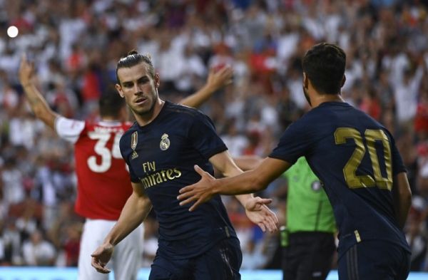 Real Madrid's Welsh forward Gareth Bale (L) celebrates with Real Madrid's Spanish midfielder Marco Asensio after scoring a goal during the International Champions Cup football match between Real Madrid and Arsenal at FedExField in Landover, Maryland, on July 23, 2019. PHOTO | AFP