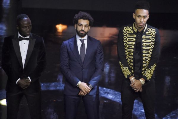 Recepient of the African Footballer of the Year Award Egypt and Liverpool striker Mohamed Salah (C) stands flanked by fellow nominees, Senegalese Sadio Mane (L) and Gabonese and Dortmund striker Pierre-Emerick Aubameyang (R) during The Confederation of African Football award ceremony at The International Conference Centre in Accra on January 4, 2018. PHOTO | AFP