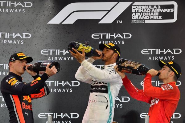 Red Bull Racing's Dutch driver Max Verstappen (L, 3rd place), Mercedes' British driver Lewis Hamilton, (C, 1st place) and Ferrari's Monegasque driver Charles Leclerc (R, 2nd place), celebrate on the podium at the Yas Marina Circuit in Abu Dhabi, after the final race of the Formula One Grand Prix Formula One Grand Prix season, on December 1, 2019. PHOTO | AFP