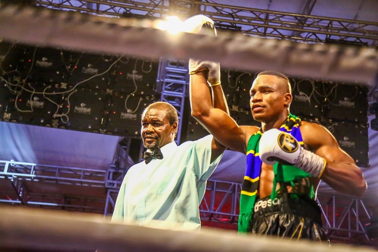 Referee Steve 'Vedo' Okumu holds the arm of Tanzania boxing sensation, Hassan 'Champez' Mwakinyo aloft after he won his men Super Welterweight fight against Sergio 'El Tigre' Gonzalez of Argentina on Saturday, March 23, 2019 during the main under card of Nairobi Fight Night 2. PHOTO/SPN