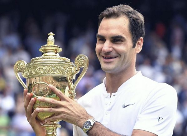 Roger Federer of Switzerland raises a victory trophy after winning the gentlemen's singles final of the Wimbledon tennis tournament against Marin Cilic of Croatia at All England Tennis Club in London on July 16, 2017. Former world number one in men's tennis Roger Federer announced his intention to retire. 41-year-old Roger Federer has claimed 20 Grand Slam titles. PHOTO | AFP