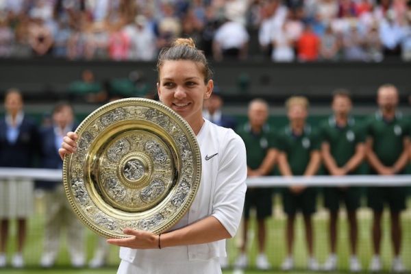 Romania's Simona Halep poses with the Venus Rosewater Dish trophy after beating US player Serena Williams during their women's singles final on day twelve of the 2019 Wimbledon Championships at The All England Lawn Tennis Club in Wimbledon, southwest London, on July 13, 2019. PHOTO/AFP