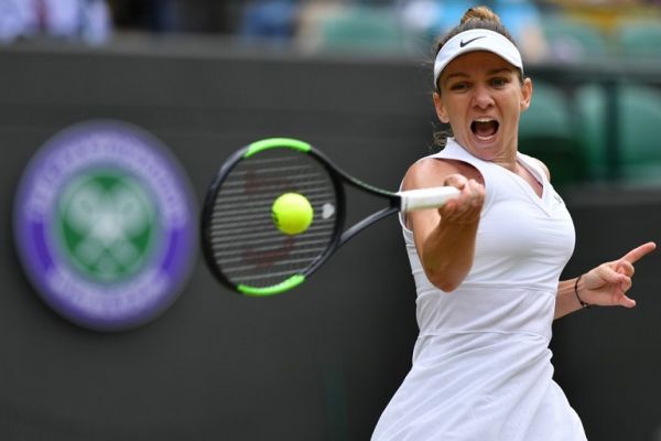 Romania's Simona Halep returns against China's Shuai Zhang during their women's singles quarter-final match on day eight of the 2019 Wimbledon Championships at The All England Lawn Tennis Club in Wimbledon, southwest London, on July 9, 2019. PHOTO | AFP