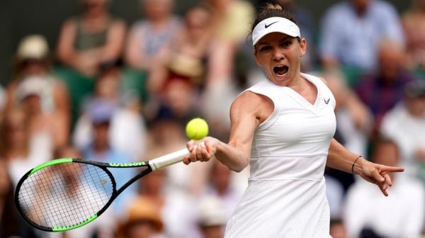 Romania's Simona Halep returns against Ukraine's Elina Svitolina during their women's singles semi-final match on day ten of the 2019 Wimbledon Championships at The All England Lawn Tennis Club in Wimbledon, southwest London, on July 11, 2019. PHOTO | AFP