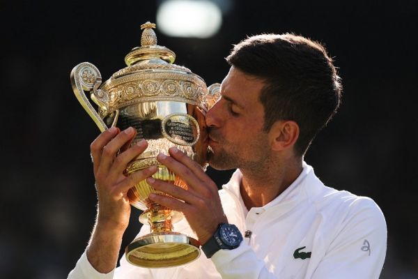 Serbia's Novak Djokovic kisses his trophy after defeating Australia's Nick Kyrgios during the men's singles final tennis match on the fourteenth day of the 2022 Wimbledon Championships at The All England Tennis Club in Wimbledon, southwest London, on July 10, 2022. PHOTO | AFP