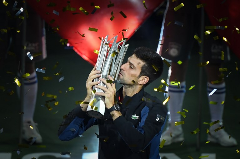 Serbia's Novak Djokovic kisses the trophy after winning his men's final singles match against Croatia's Borna Coric at the Shanghai Masters tennis tournament in Shanghai on October 14, 2018. PHOTO/AFP