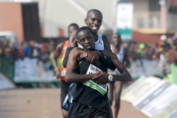 Simon Cheprot carries injured compatriot Kenneth Kipkemoi across the line in the 2019 Okpekpe International 10Km race on Saturday, May 25, 2019. PHOTO/Courtesy