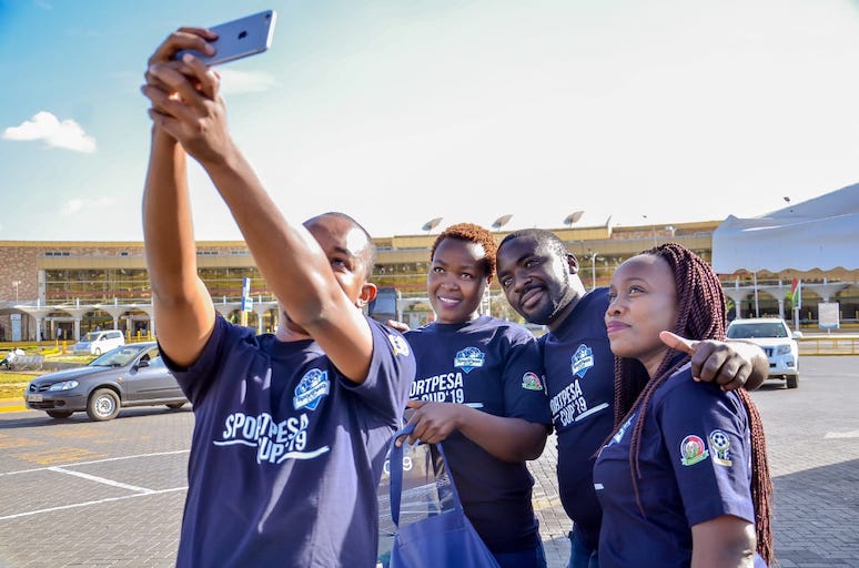 SNAPPING HAPPINESS: Winners of the 'Win A Trip' online competition take a selfie at the Jomo Kenyatta International Airport, Nairobi ahead of their flight to Dar-es-Salaam, Tanzania for the 2019 SportPesa Cup final on Saturday, January 26, 2019. PHOTO/SPN