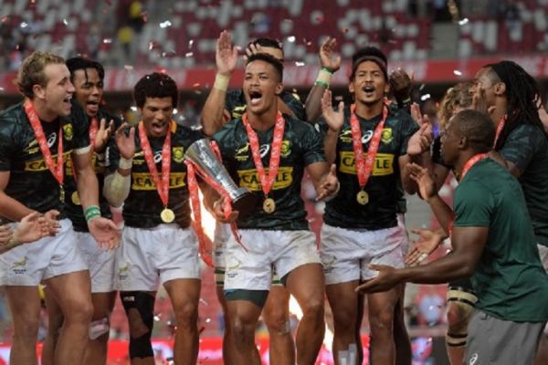 South Africa's team celebrates after winning the Singapore Rugby Sevens Cup final match against Fiji in Singapore on April 14, 2019. PHOTO/AFP