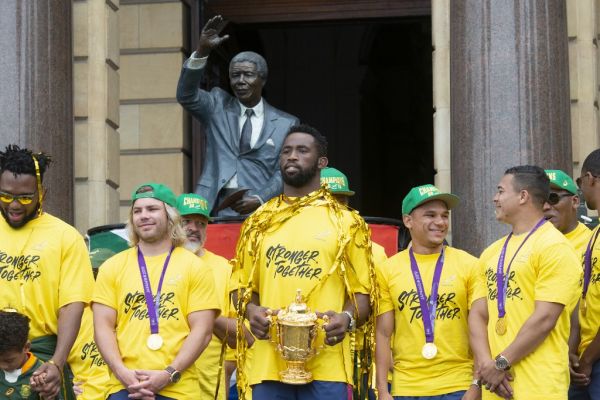 South African Rugby captain Siya Kolisi (C) holds the Web Ellis Trophy during the South African Rugby World Cup winner team's last stop to parade the Web Ellis Trophy at the Cape Town City Hall in Cape Town, on November 11, 2019. PHOTO | AFP