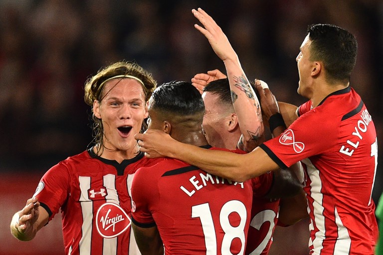 Southampton's Danish midfielder Pierre-Emile Hojbjerg (C) celebrates with teammates after scoring the team's first goal during the English Premier League football match between Southampton and Brighton at St Mary's Stadium in Southampton, southern England on September 17, 2018. PHOTO/AFP