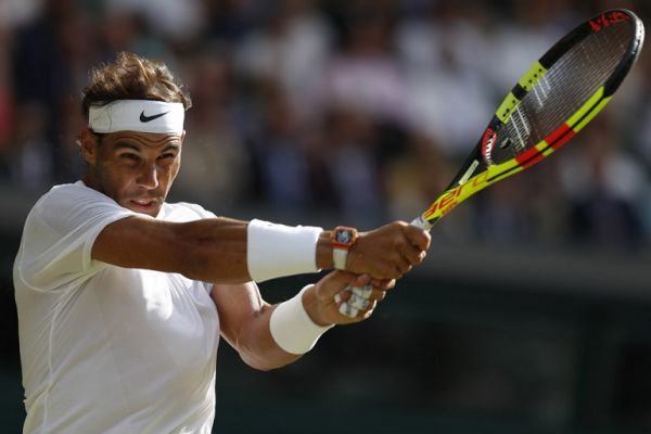 Spain's Rafael Nadal returns against Australia's Nick Kyrgios during their men's singles second round match on the fourth day of the 2019 Wimbledon Championships at The All England Lawn Tennis Club in Wimbledon, southwest London, on July 4, 2019. PHOTO | AFP