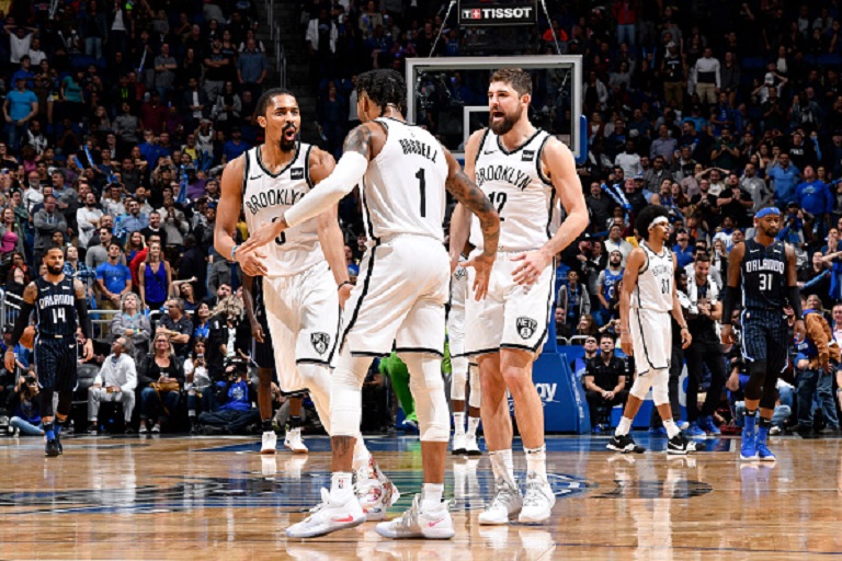 Spencer Dinwiddie #8, D'Angelo Russell #1, and Joe Harris #12 of the Brooklyn Nets react to a plau during the game against the Orlando Magic on January 18, 2019 at Amway Center in Orlando, Florida. PHOTO/GETTY IMAGES