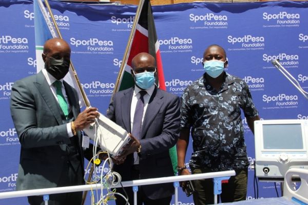 SportPesa CEO Captain Ronald Karauri (left) presents donations for the Longisa Hospital alongside Mega Jackpot winner Cosmas Korir (right) in Bomet County on Thursday, August 26, 2021. PHOTO | Courtesy