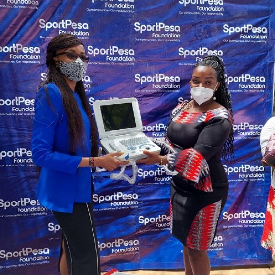 SportPesa Foundation's Project Manager Esther Matere (left) presents hospital equipment to Ruben Health Centre's head Zipporah Mwangi on Friday, September 24, 2021. PHOTO | Courtesy