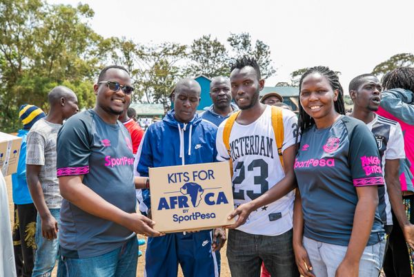 SportPesa Head of Public Relations Lola Okulo (right) poses with a team captain from one of the 16 teams that received jerseys courtesy of the Kits of Africa initiative in Kibera on Friday, August 9, 2019. PHOTO | ANTHONY MWAKI | SPN