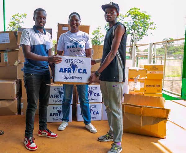 SportPesa's Head of Public Relations Lola Okulo (centre) presents a box of kits to team representatives at the Thika Municipal Stadium on Friday, November 29, 2019. PHOTO | Duncan Sirma | SPN