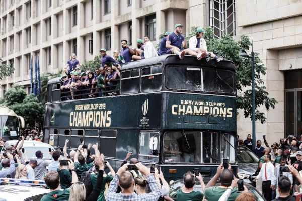 Springbok supporters celebrate while the South African Rugby World Cup winner team parades through the Durban CBD on an open top bus in Durban, on November 8, 2019. The Springboks first dominated and then crushed pre-match favourites England 32-12 in Japanese city Yokohama last Saturday to lift the World Cup a record-equalling third time. PHOTO | AFP