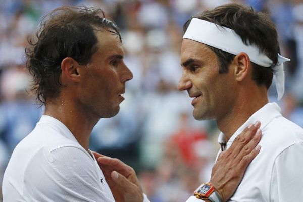 Switzerland's Roger Federer (R) shakes hands and embraces Spain's Rafael Nadal (L) after Federer won their men's singles semi-final match on day 11 of the 2019 Wimbledon Championships at The All England Lawn Tennis Club in Wimbledon, southwest London, on July 12, 2019. PHOTO/AFP