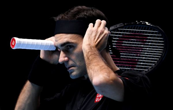 Switzerland's Roger Federer adjusts his headband during his group stage men's singles tennis match against Serbia's Novak Djokovic at the ATP World Tour Finals tournament in London, Britain. PHOTO | AFP