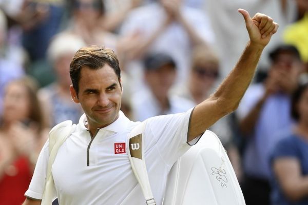 Switzerland's Roger Federer waves as he leaves the court after beating Japan's Kei Nishikori during their men's singles quarter-final match on day nine of the 2019 Wimbledon Championships at The All England Lawn Tennis Club in Wimbledon, southwest London, on July 10, 2019. PHOTO/AFP