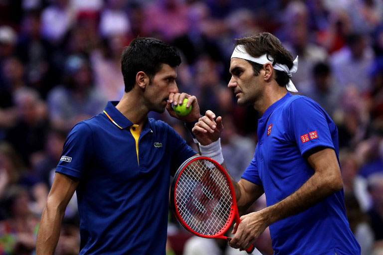 Team Europe Roger Federer of Switzerland and Team Europe Novak Djokovic of Serbia react against Team World Jack Sock of the United States and Team World Kevin Anderson of South Africa during their Men's Doubles match on day one of the 2018 Laver Cup at the United Center on September 21, 2018 in Chicago, Illinois. Matthew Stockman/Getty Images for The Laver Cup. PHOTO/AFP