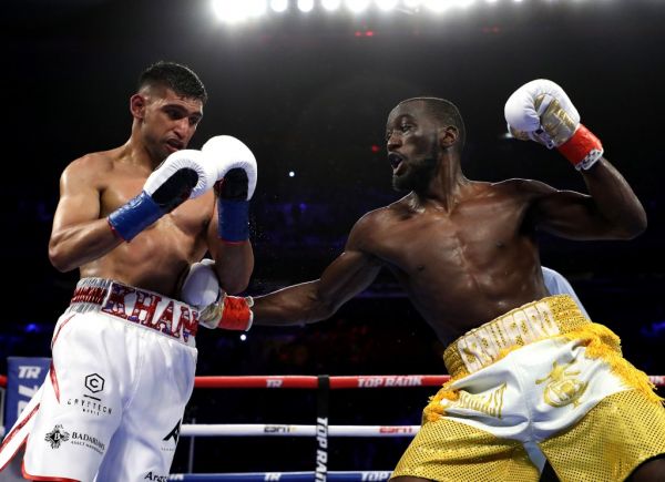 Terence Crawford punches Amir Khan during their WBO welterweight title fight at Madison Square Garden on April 20, 2019 in New York City. PHOTO | AFP