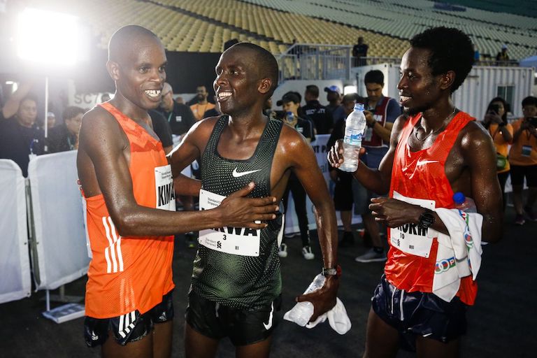 The Kenya men’s winners (from left: third-placed Andrew Kimtai, runner-up Felix Kirwa and champion Joshua Kipkorir) celebrate their feat at the Standard Chartered Singapore Marathon. PHOTO/AFP