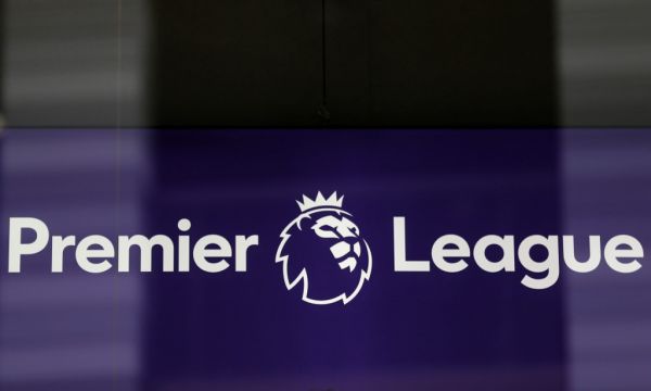 The logo is pictured through a glass window at the headquarters of the English Premier League in London on March 13, 2020. The English Premier League suspended all fixtures until April 4 on Friday after Arsenal manager Mikel Arteta and Chelsea winger Callum Hudson-Odoi tested positive for coronavirus. PHOTO | AFP