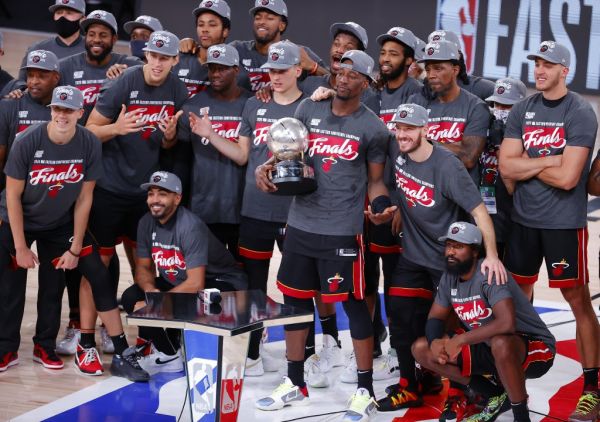 The Miami Heat celebrate with the trophy after they are Eastern Finals Champions against the Boston Celtics in Game Six of the Eastern Conference Finals during the 2020 NBA Playoffs at AdventHealth Arena at the ESPN Wide World Of Sports Complex on September 27, 2020 in Lake Buena Vista, Florida. PHOTO | AFP